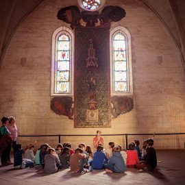 Barcelona, Spain - October 28, 2015: Children are listening of teacher at the Monastery of Pedralbes in Barcelona, Catalonia, Spain on 28 October, 2015.