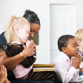 A group of multi-ethnic children at Sunday School in a real church classroom