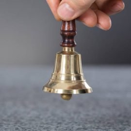 Close-up Of A Person Hand Holding A Ring Bell